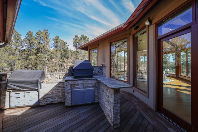 wooden deck with exterior kitchen and grilling area