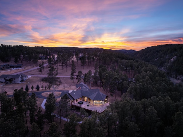 birds eye view of property with a mountain view and a view of trees