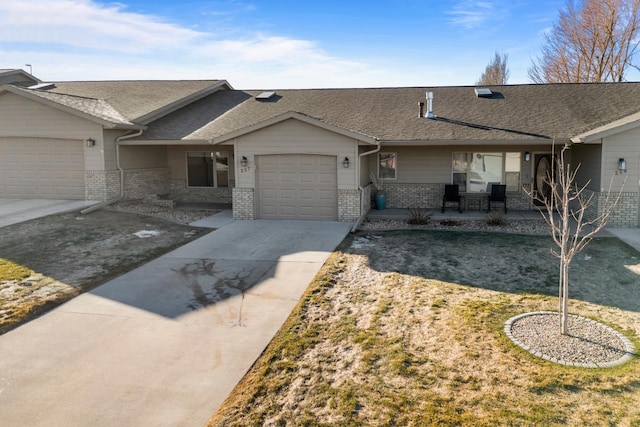 ranch-style home featuring brick siding, driveway, an attached garage, and roof with shingles