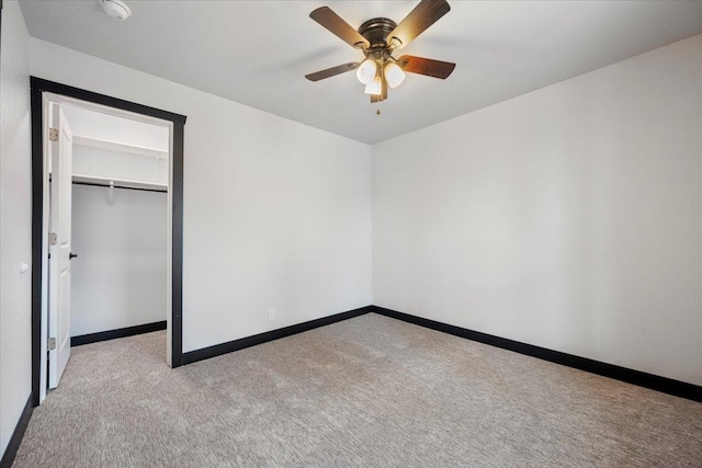 unfurnished bedroom featuring a closet, carpet, a ceiling fan, and baseboards