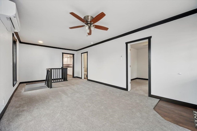 unfurnished room featuring baseboards, ornamental molding, carpet flooring, and a wall mounted air conditioner