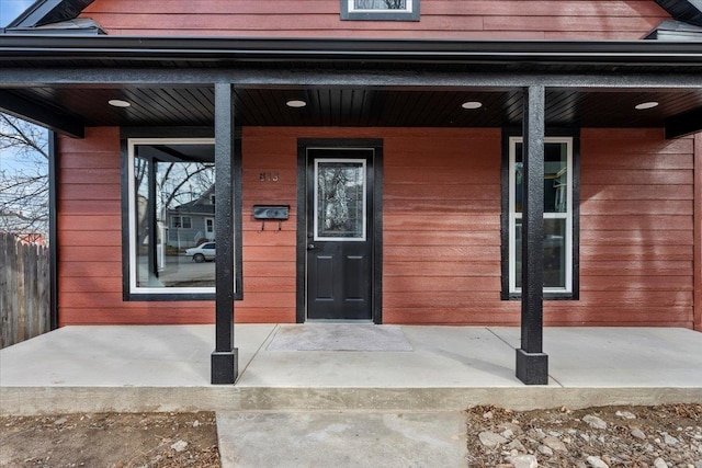 view of exterior entry featuring a porch