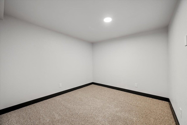 carpeted spare room with baseboards