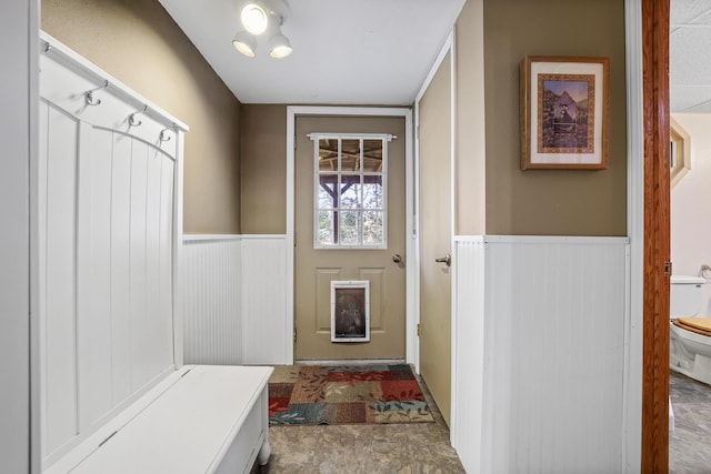 mudroom with a wainscoted wall