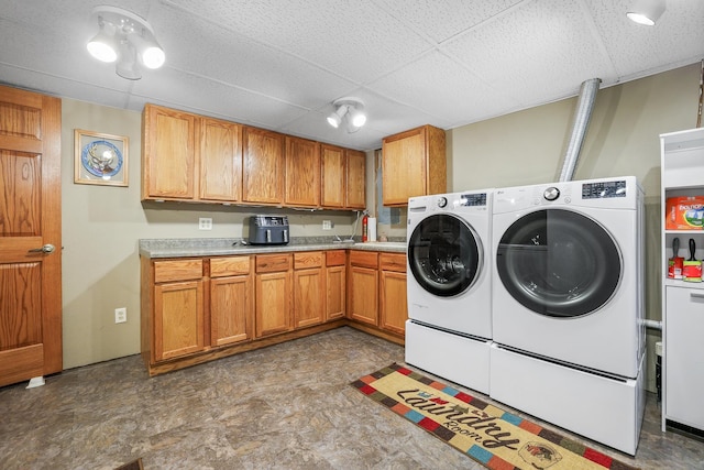 clothes washing area featuring cabinet space and separate washer and dryer