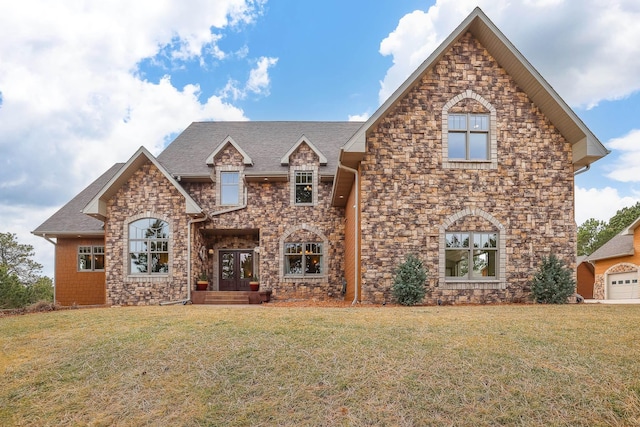 view of front of property featuring stone siding, a shingled roof, and a front lawn