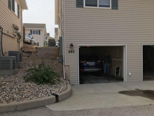 view of home's exterior featuring a garage, driveway, and cooling unit