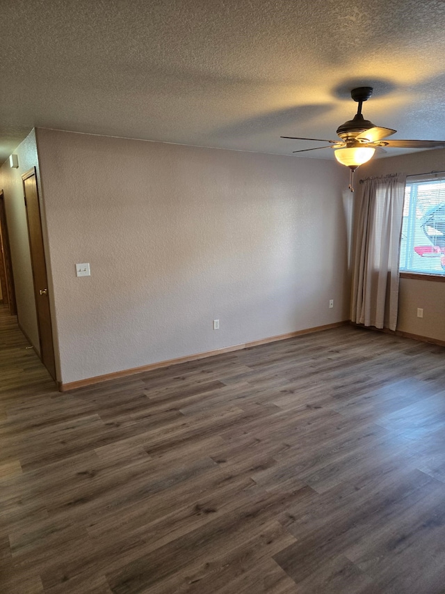 spare room featuring ceiling fan, a textured ceiling, and dark wood-style flooring