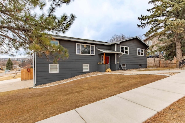 split foyer home featuring fence