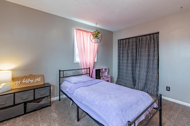 carpeted bedroom featuring baseboards