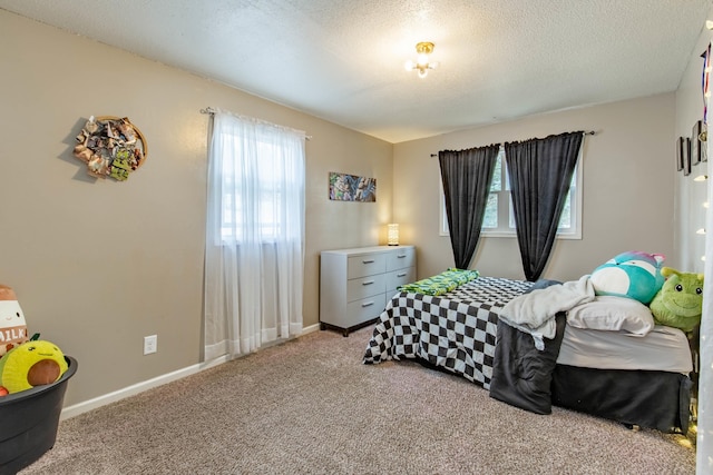 carpeted bedroom featuring baseboards and a textured ceiling