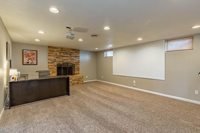 carpeted living room featuring recessed lighting, visible vents, a fireplace, and baseboards