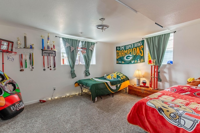 carpeted bedroom with multiple windows and a textured ceiling