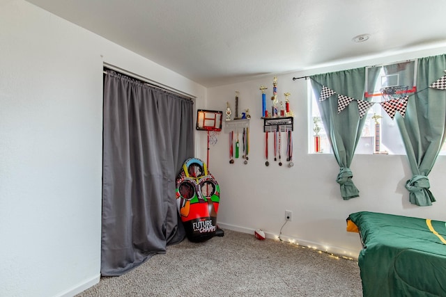 playroom featuring carpet floors and baseboards