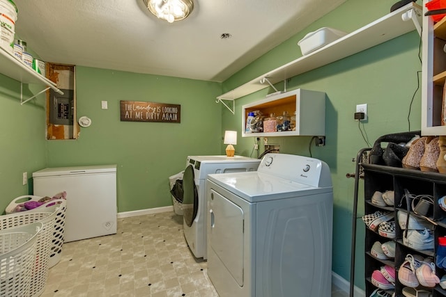 laundry area with laundry area, separate washer and dryer, baseboards, electric panel, and light floors