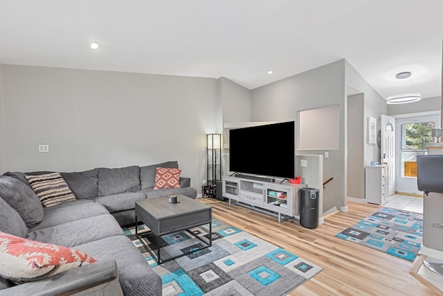 living area with baseboards, recessed lighting, and light wood-style floors