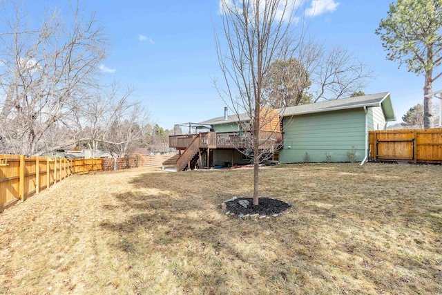 rear view of house with a fenced backyard, stairs, and a wooden deck