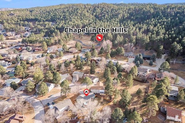 birds eye view of property featuring a residential view and a view of trees