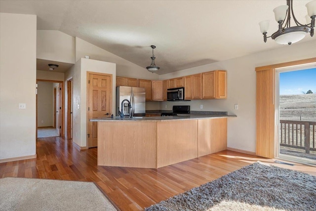 kitchen with stainless steel appliances, lofted ceiling, pendant lighting, and light wood-style floors