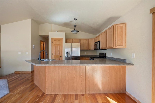 kitchen featuring stainless steel refrigerator with ice dispenser, light wood finished floors, black electric range oven, a sink, and a peninsula