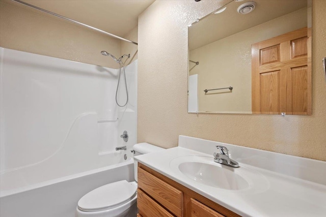 bathroom featuring visible vents, a textured wall, toilet, tub / shower combination, and vanity