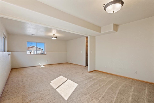 empty room with baseboards and carpet flooring