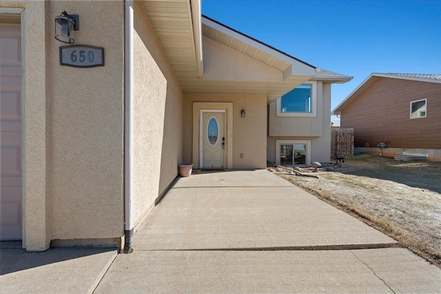 view of exterior entry with stucco siding