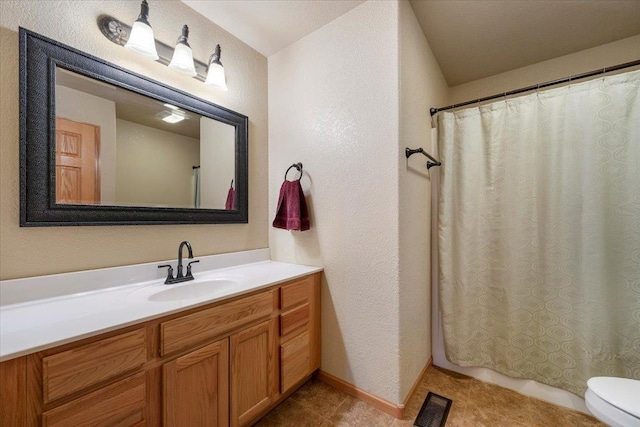 bathroom with tile patterned flooring, toilet, vanity, visible vents, and shower / bath combo with shower curtain