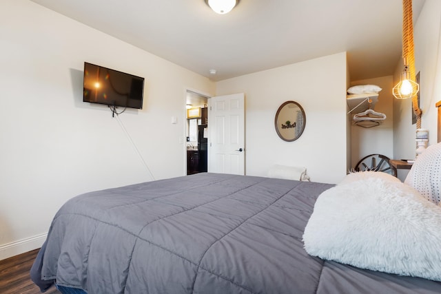 bedroom featuring dark wood-type flooring and baseboards