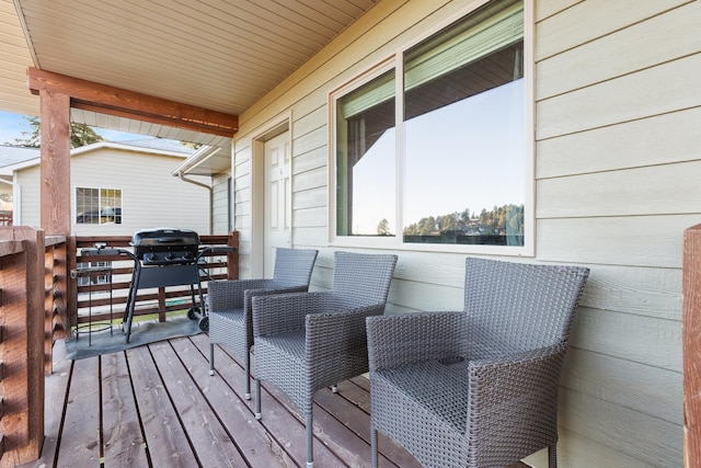 wooden deck with a grill