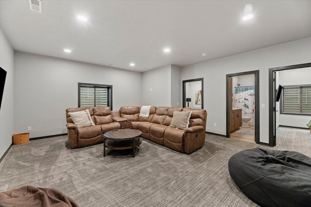 living area featuring recessed lighting, visible vents, light carpet, and baseboards