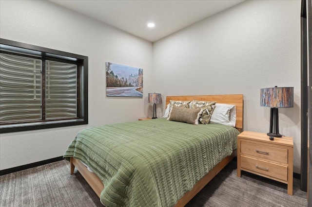 bedroom with a textured wall, carpet, and recessed lighting