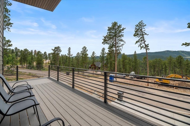 wooden terrace with a view of trees