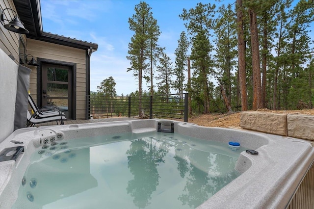 view of swimming pool featuring a hot tub