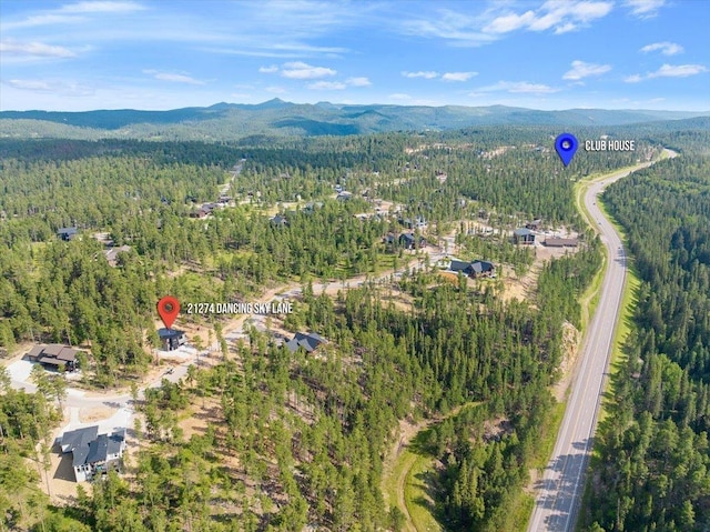 birds eye view of property with a mountain view and a view of trees