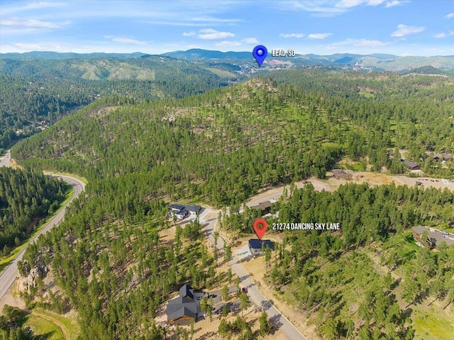 aerial view with a mountain view and a wooded view