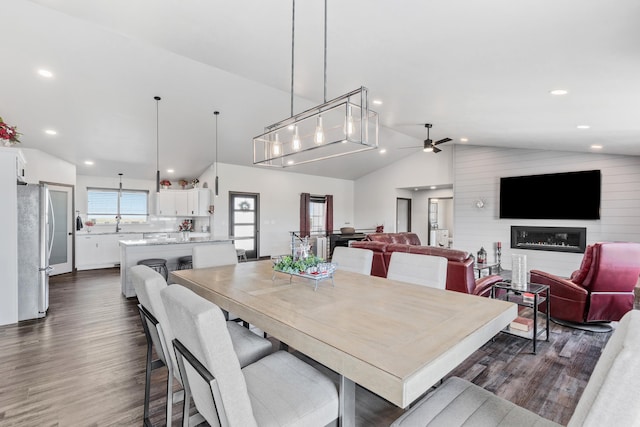 dining space featuring dark wood-style floors, ceiling fan, vaulted ceiling, and recessed lighting