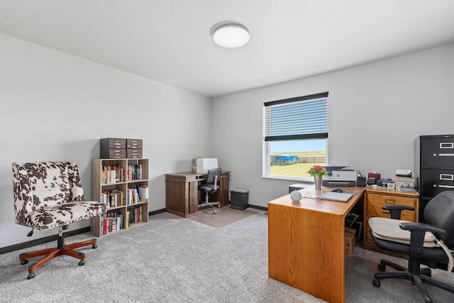 carpeted office space featuring baseboards