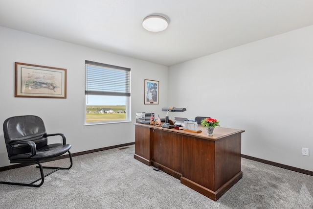 office space with light carpet and baseboards