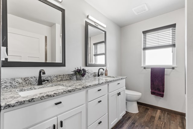 full bathroom featuring visible vents, wood finished floors, a sink, and toilet