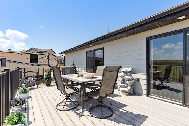 deck with outdoor dining area