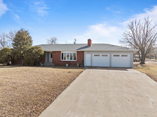 ranch-style home featuring a garage, driveway, a chimney, and brick siding