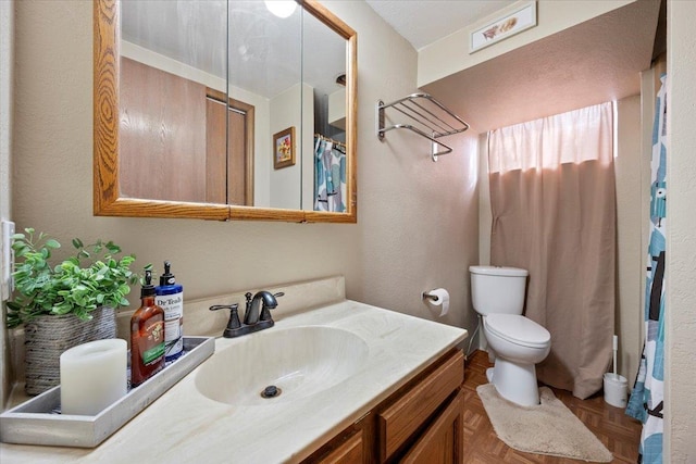 bathroom featuring toilet and vanity