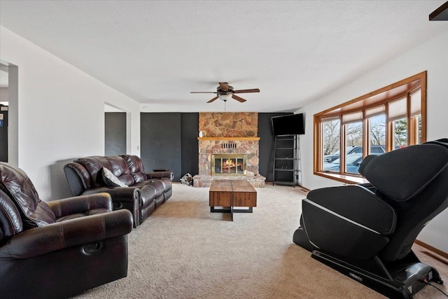 living room featuring carpet floors, a fireplace, and a ceiling fan