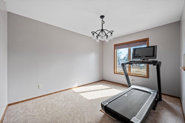 workout room featuring baseboards, a chandelier, and carpet flooring