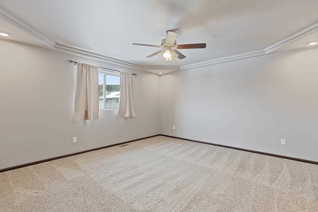 carpeted spare room with ornamental molding, ceiling fan, and baseboards