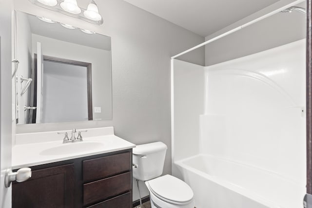 bathroom with toilet,  shower combination, and vanity