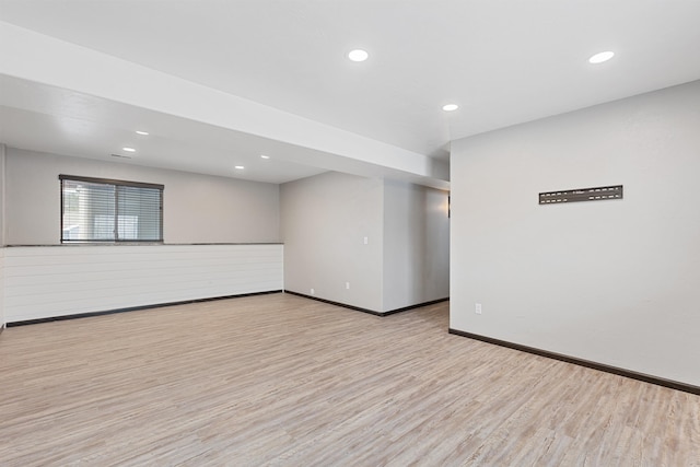 spare room featuring recessed lighting, baseboards, and light wood finished floors