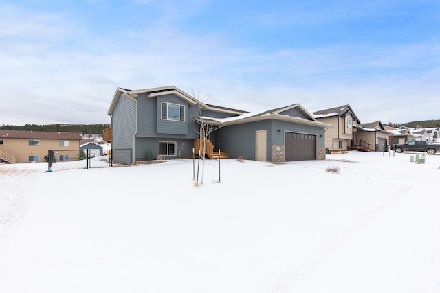 view of front of house with a garage and fence