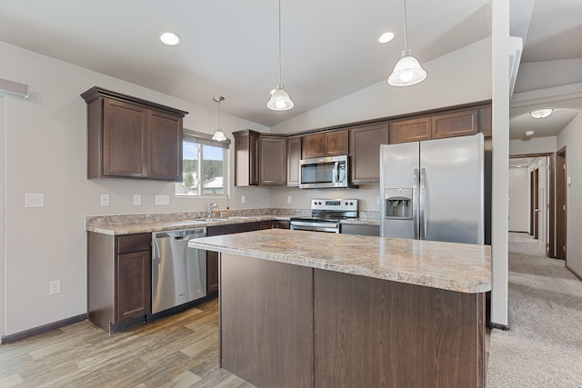 kitchen featuring stainless steel appliances, lofted ceiling, light countertops, dark brown cabinetry, and a sink